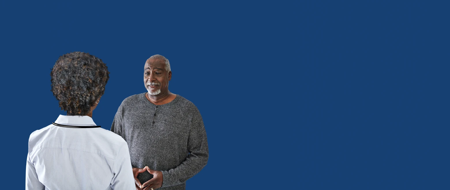 Healthcare provider speaking with an older man